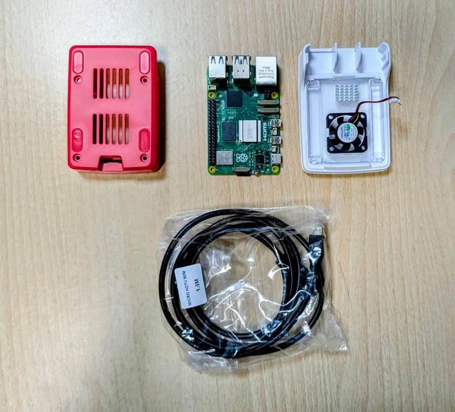 Raspberry Pi 5 board with its red and white case, cooling fan and a micro-HDMI cable