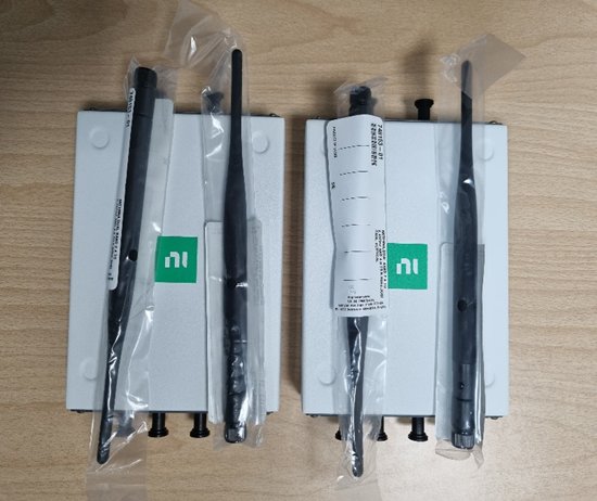 Two NI USRP-2901 units seen from above, with Vert2450 vertical antennas